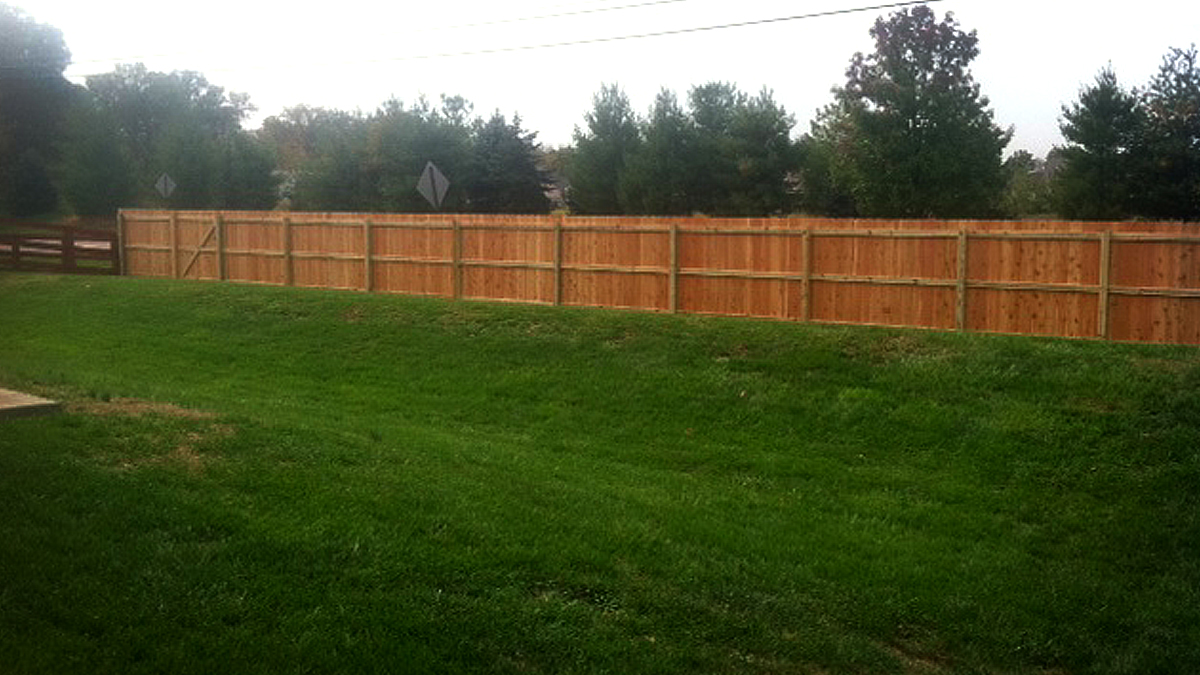 Block noise and prying eyes with a wood privacy fence from Ashlee Fence.